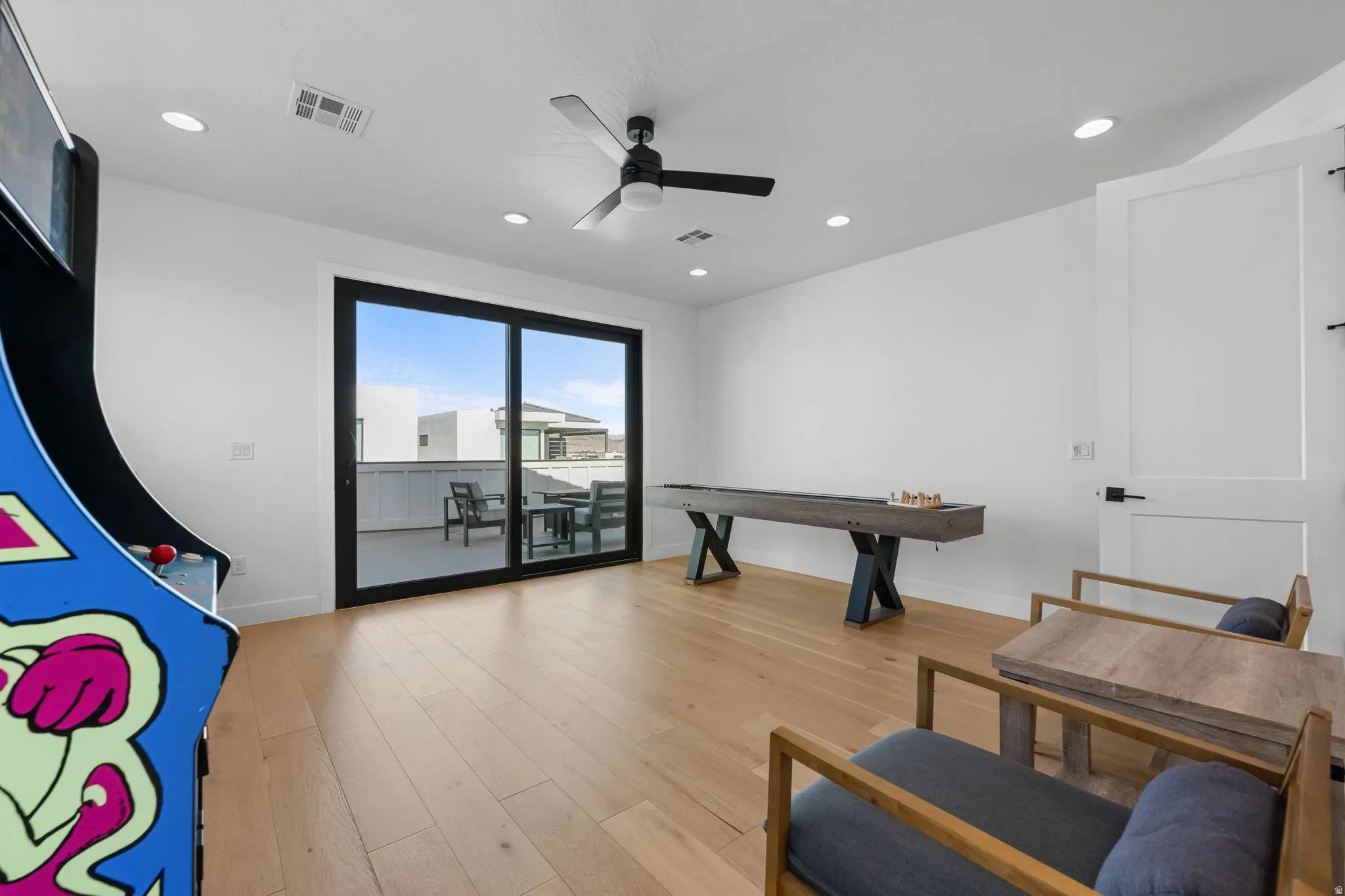 Game room featuring light wood-type flooring, ceiling fan, and recessed lighting