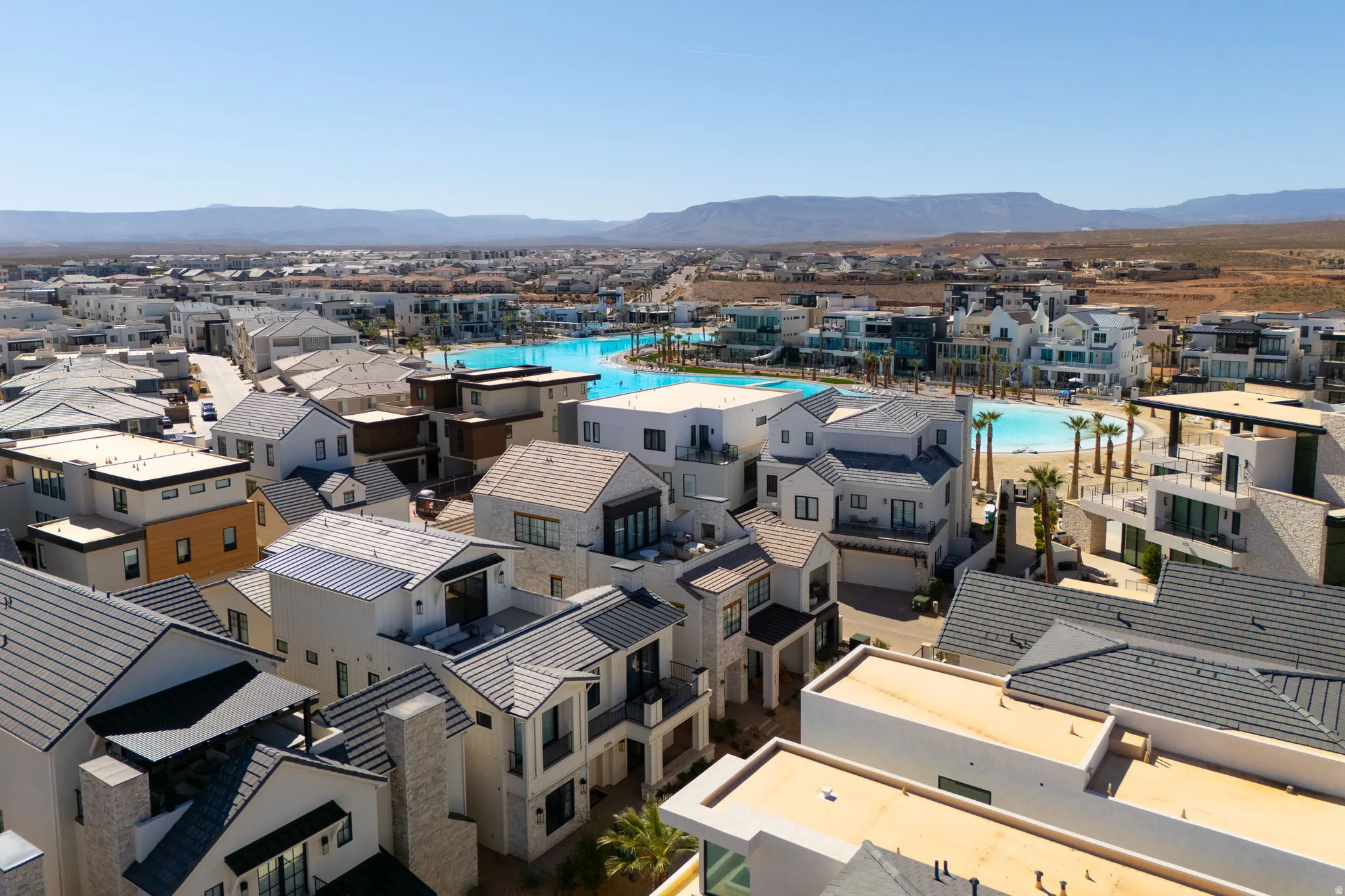 Aerial perspective of suburban area with mountains and a pool area