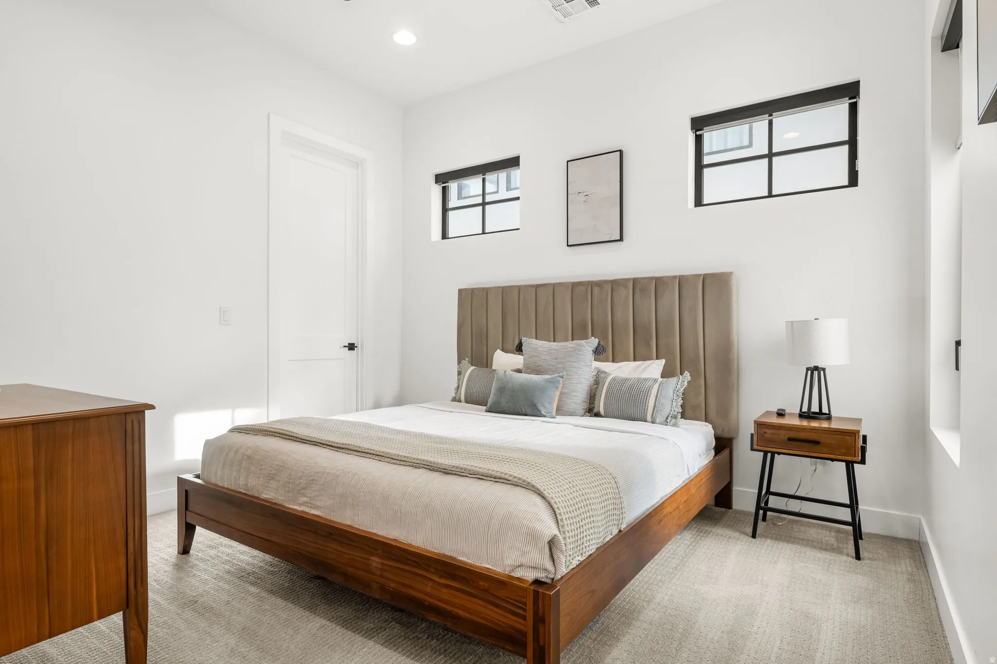 Bedroom with light carpet and recessed lighting