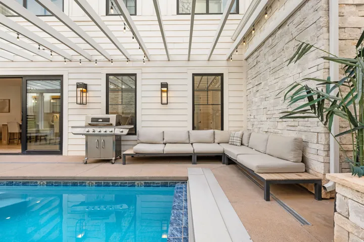 Swimming pool featuring grilling area, a patio area, outdoor seating, and a pergola