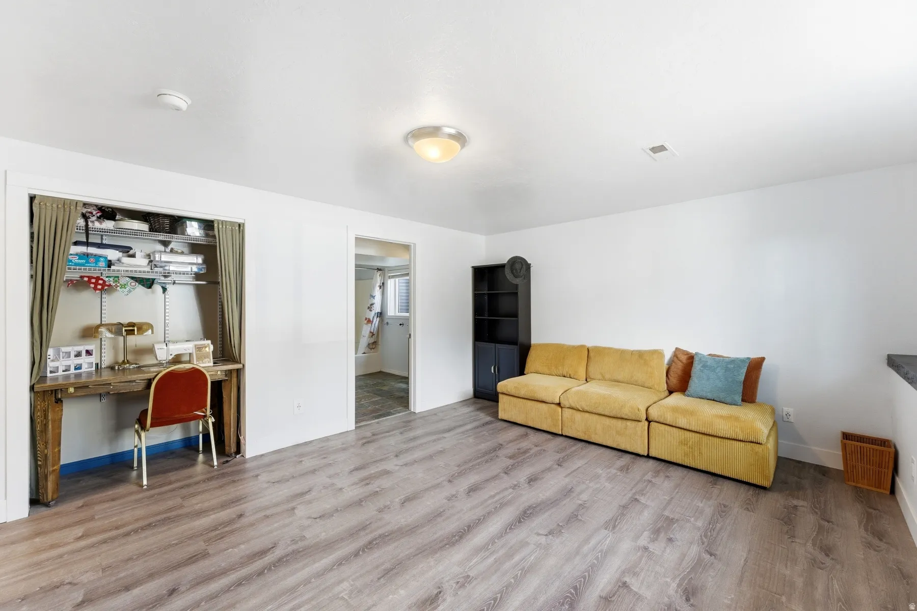 Living room with light wood-type flooring and baseboards