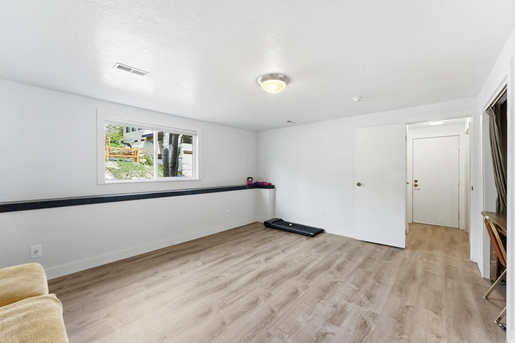 Spare room featuring light wood finished floors and baseboards