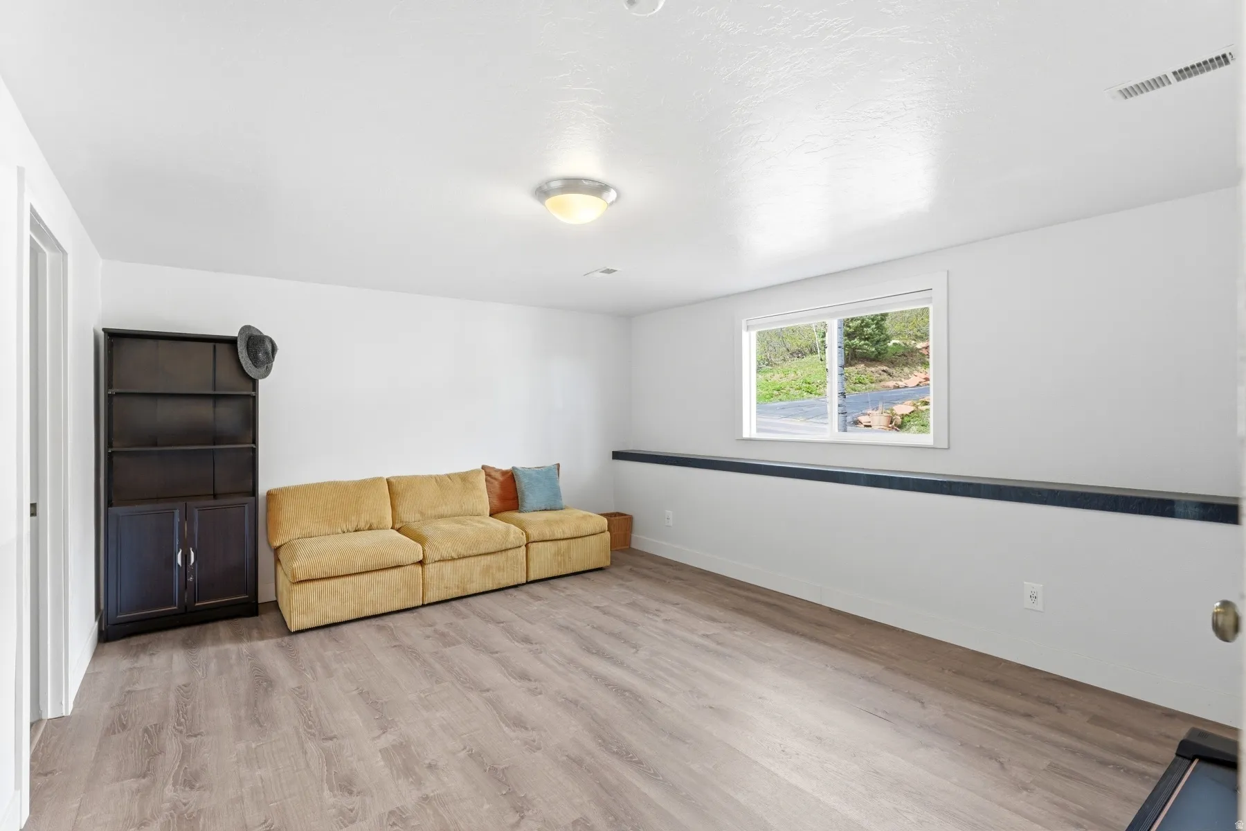 Sitting room featuring light wood-style floors and baseboards