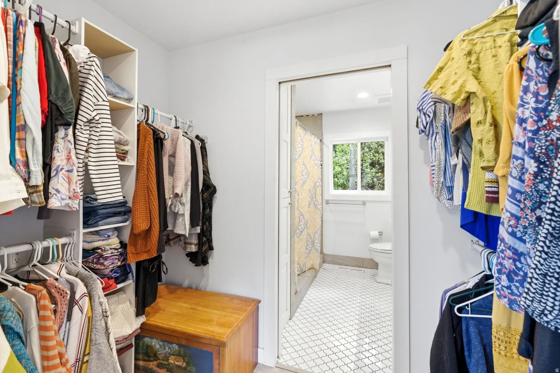 Walk in closet with light tile patterned floors