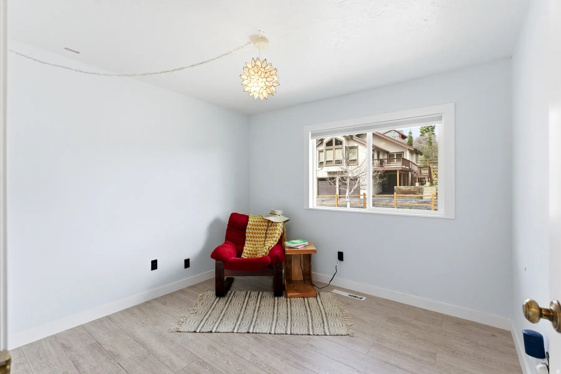 Living area with light wood-style floors and baseboards