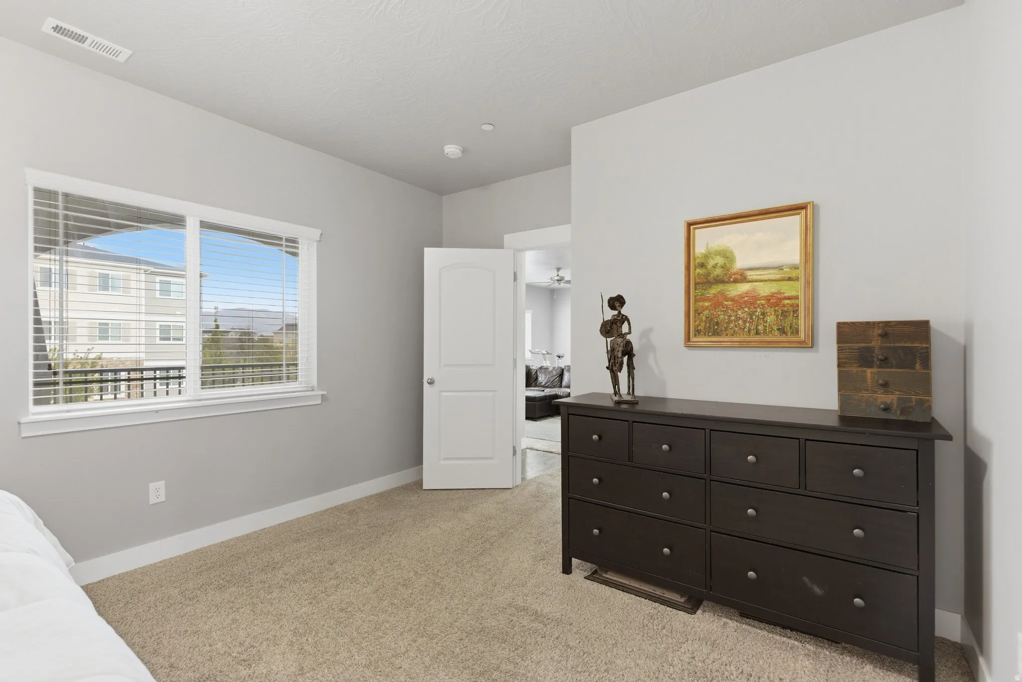Bedroom with light carpet and baseboards