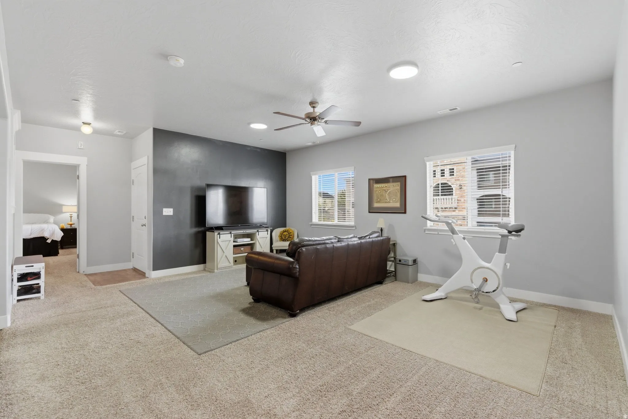 Living room with light carpet and a ceiling fan