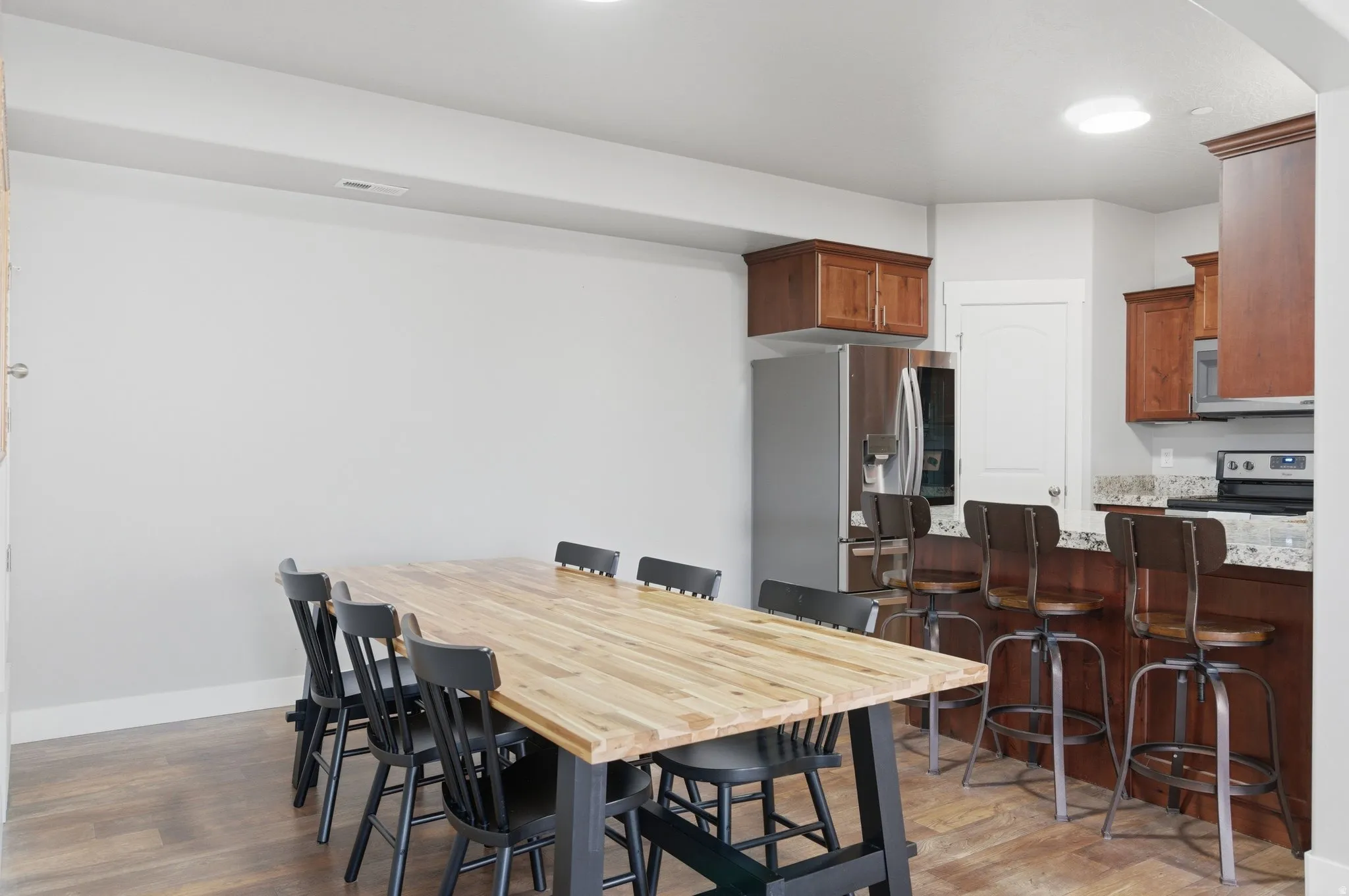 Dining room featuring light wood-type flooring and baseboards