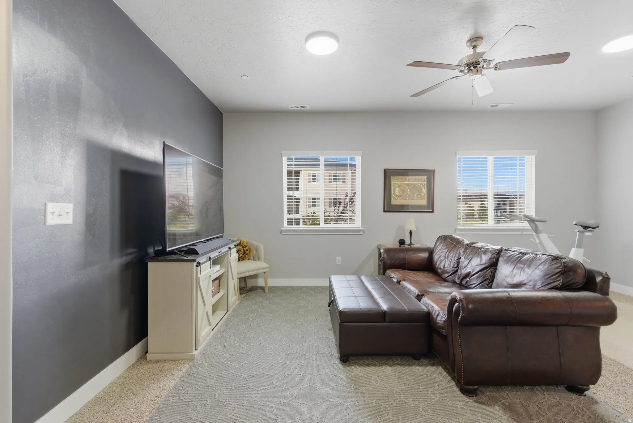 Living room with baseboards and a ceiling fan