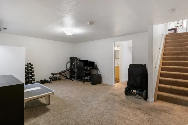 Home office featuring light carpet and a textured ceiling