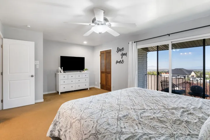 Bedroom featuring access to exterior, a closet, a ceiling fan, light colored carpet, and recessed lighting