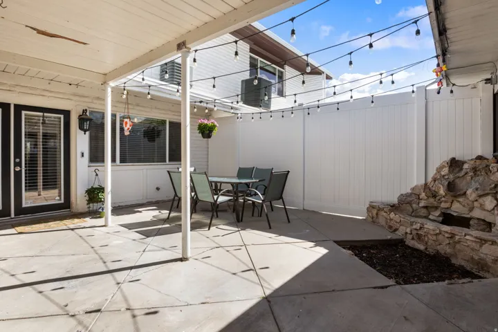 Fenced backyard with outdoor dining area and a patio area