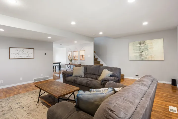 Living area featuring light wood-style flooring and recessed lighting