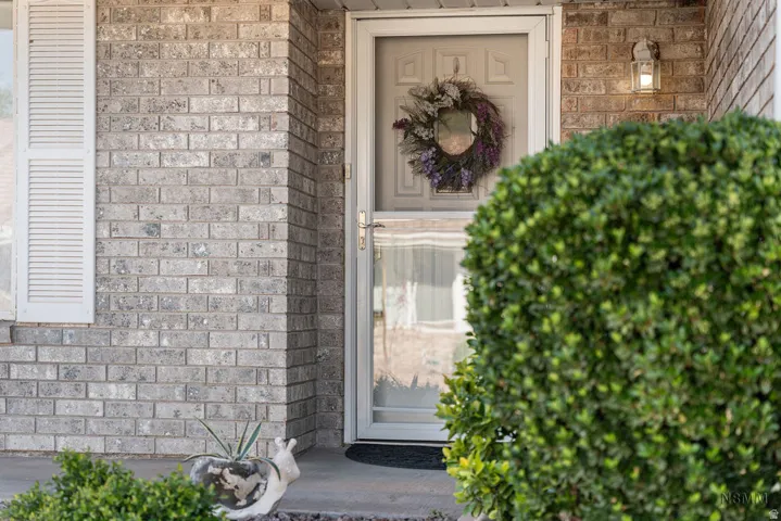 Entrance to property with brick siding