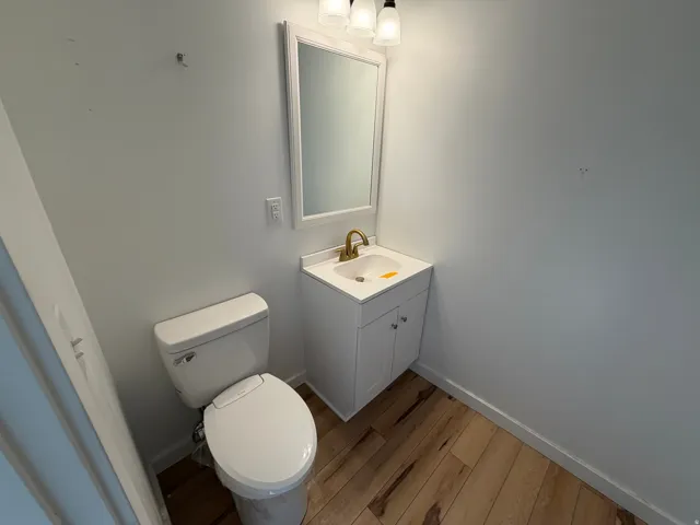 Half bath featuring vanity and light wood-type flooring