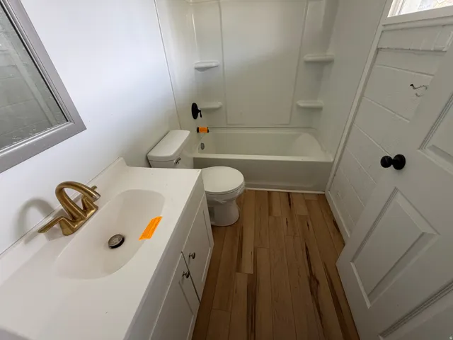 Bathroom with vanity, light wood finished floors, and shower / tub combination