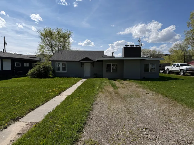 Single story home with a front lawn