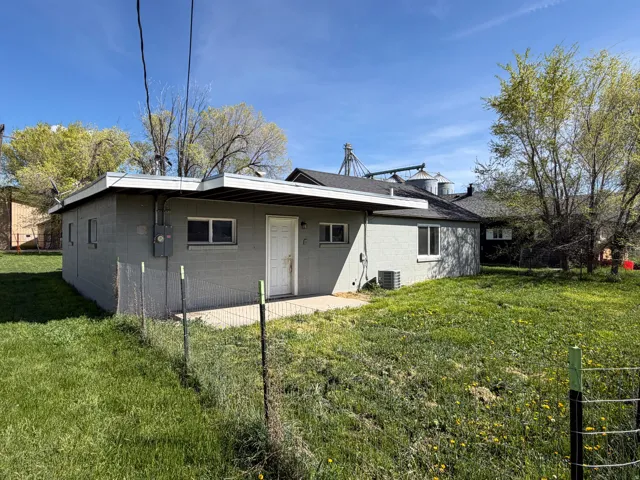 Back of property featuring concrete block siding
