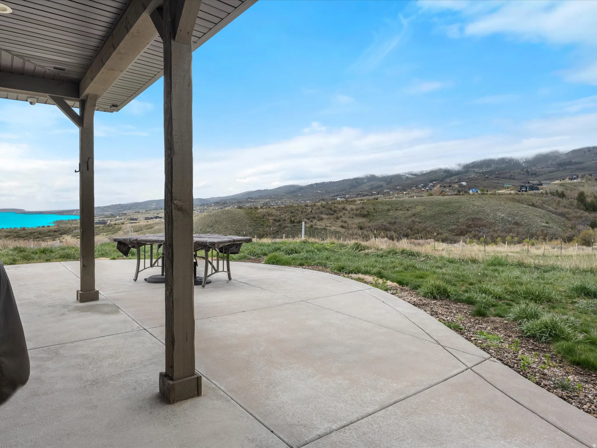 View of patio / terrace featuring a mountain and lake view