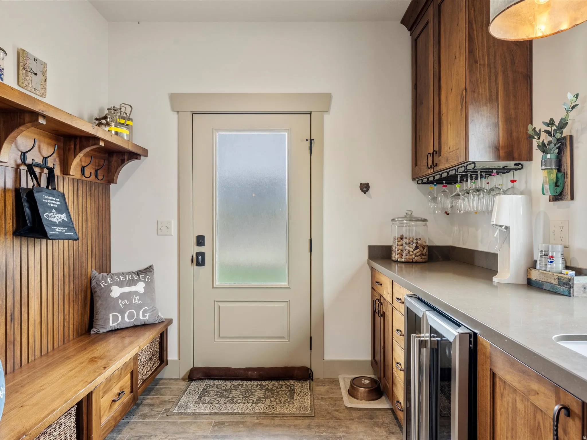 Mudroom featuring wine cooler, bar area, and light wood finished floors