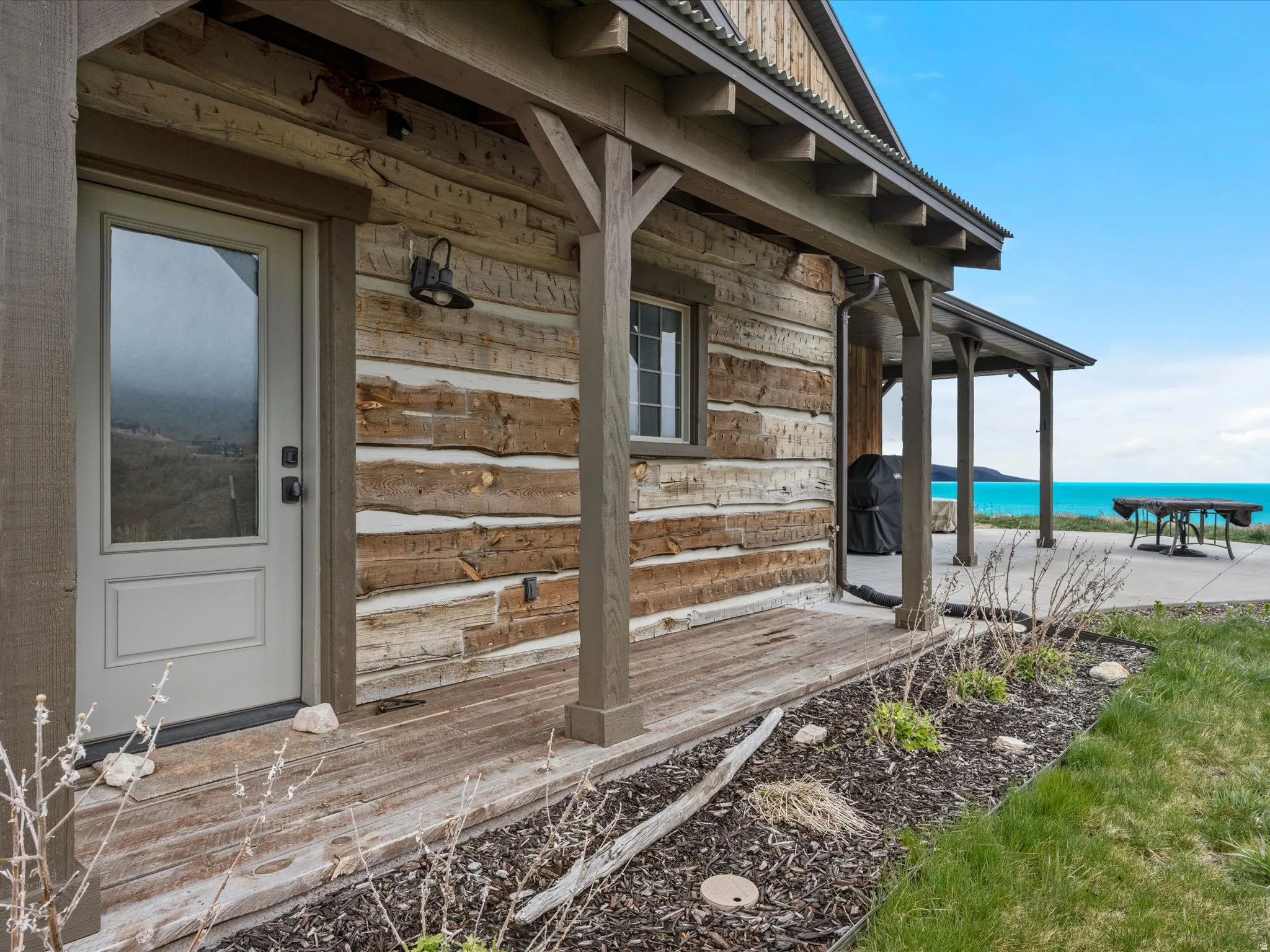 Mud room entry View of exterior entry featuring a Lake view and covered porch