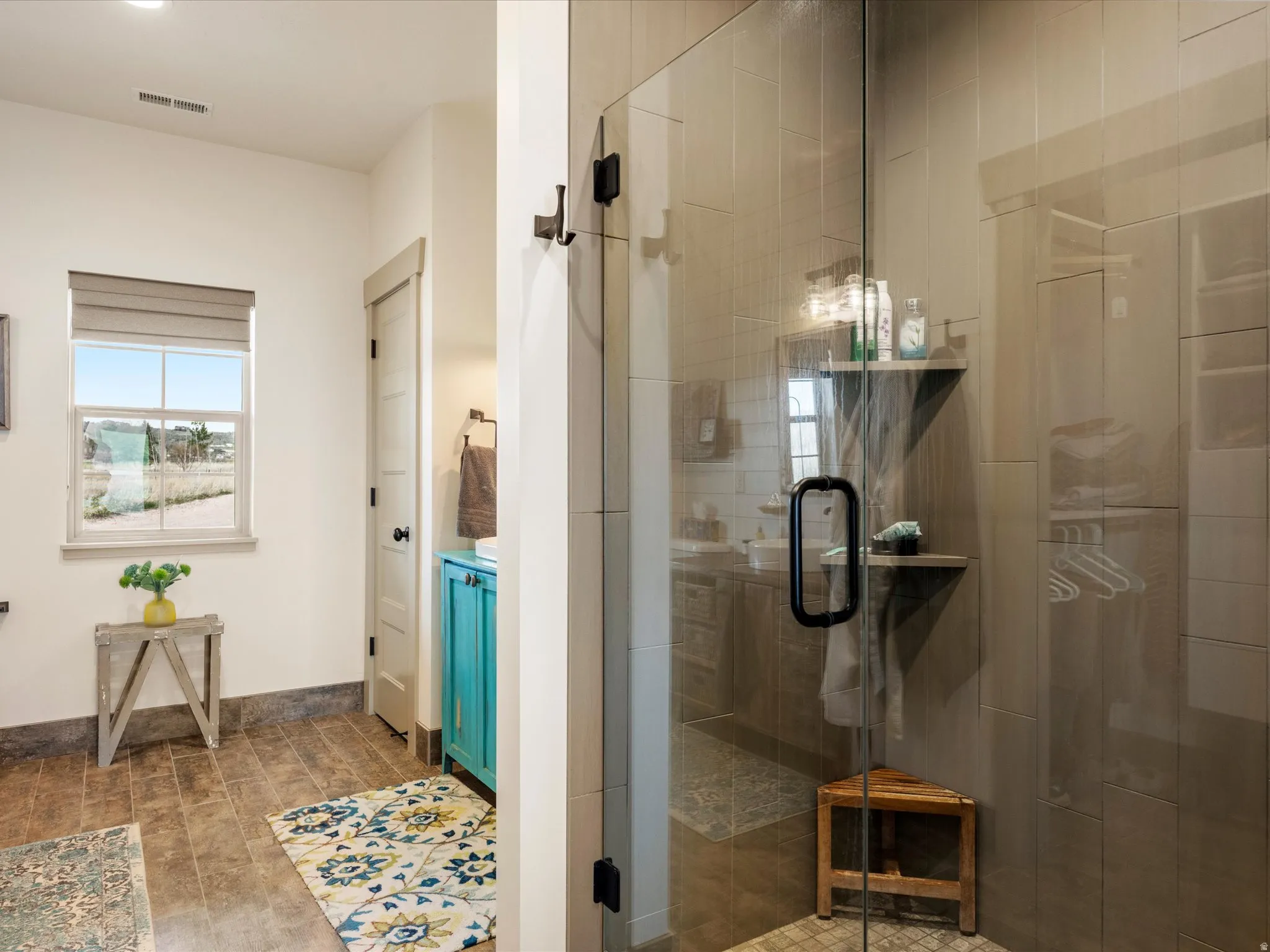 Ensuite Bathroom featuring a stall shower and light wood-style floors