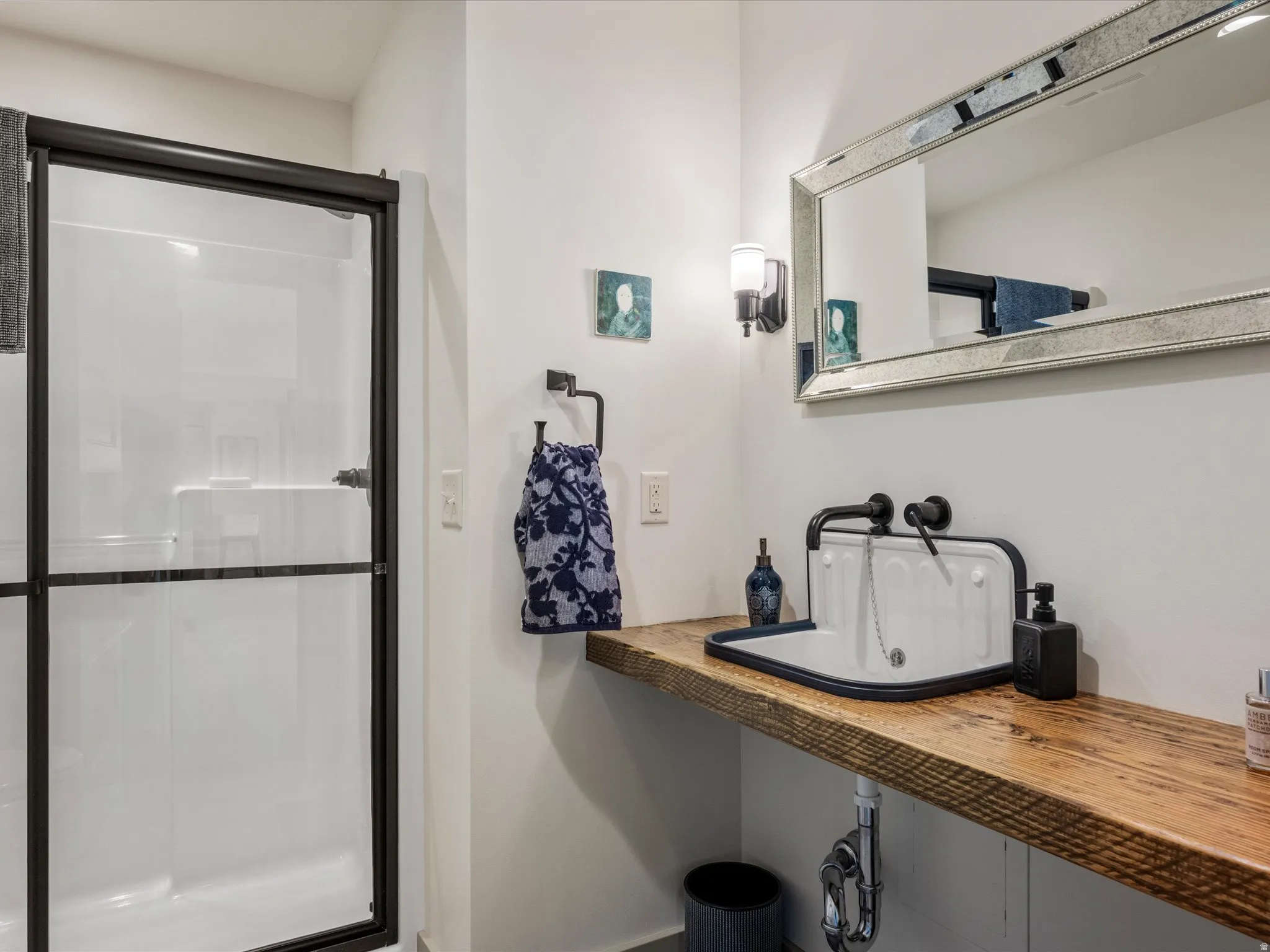 Bathroom with a stall shower and vanity