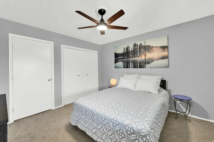 Upstairs bedroom with closet and door to the 3rd bedroom* lofted space with pony wall.