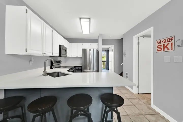 Updated Kitchen with two-tone paint and quarts countertops with stainless steel appliance package.