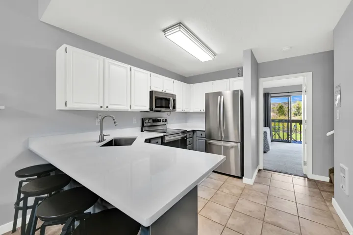 Updated Kitchen with two-tone paint and quarts countertops with stainless steel appliance package.