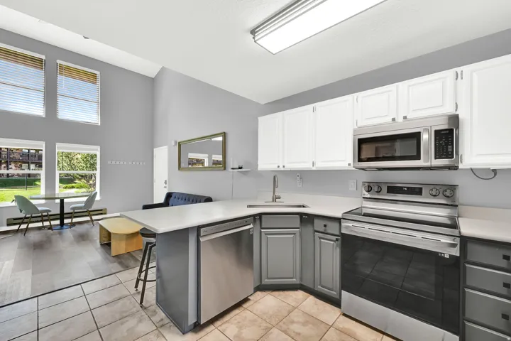 Updated Kitchen with two-tone paint and quarts countertops with stainless steel appliance package.