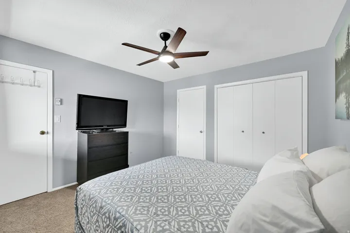 Upstairs bedroom with closet and door to the 3rd bedroom* lofted space with pony wall.