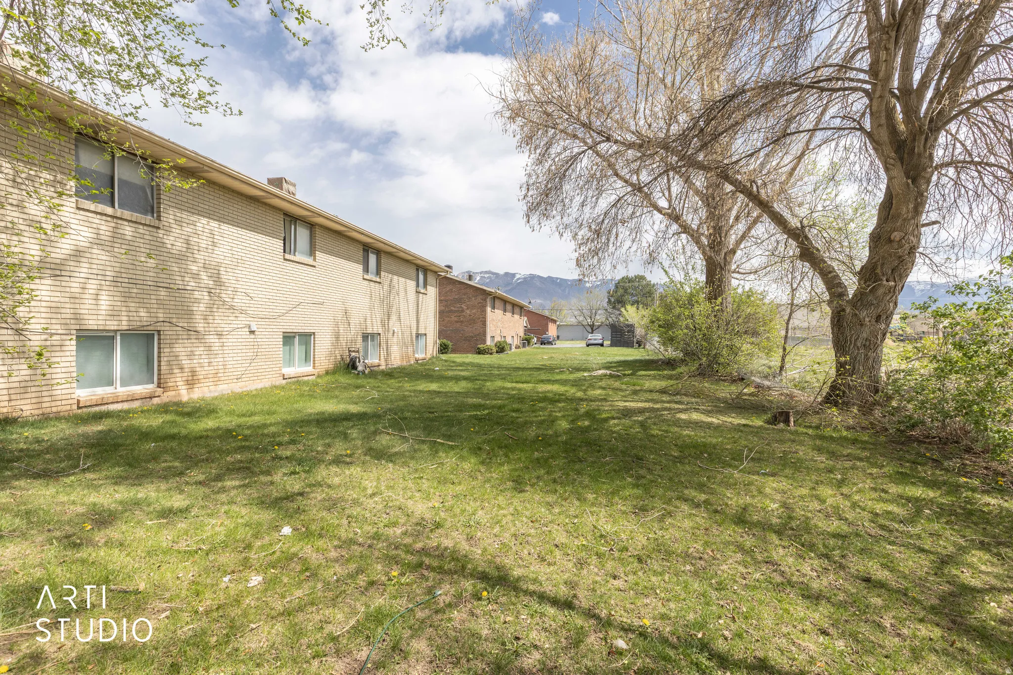 View of grassy yard with a mountain view