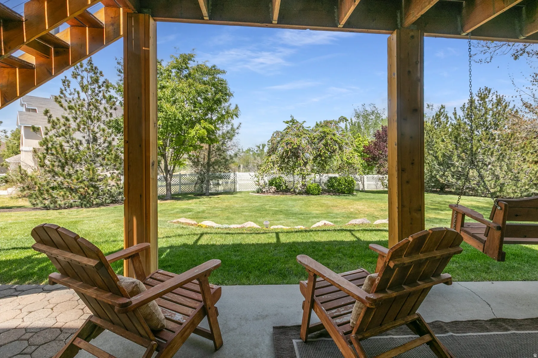 Partial fenced backyard with a patio area