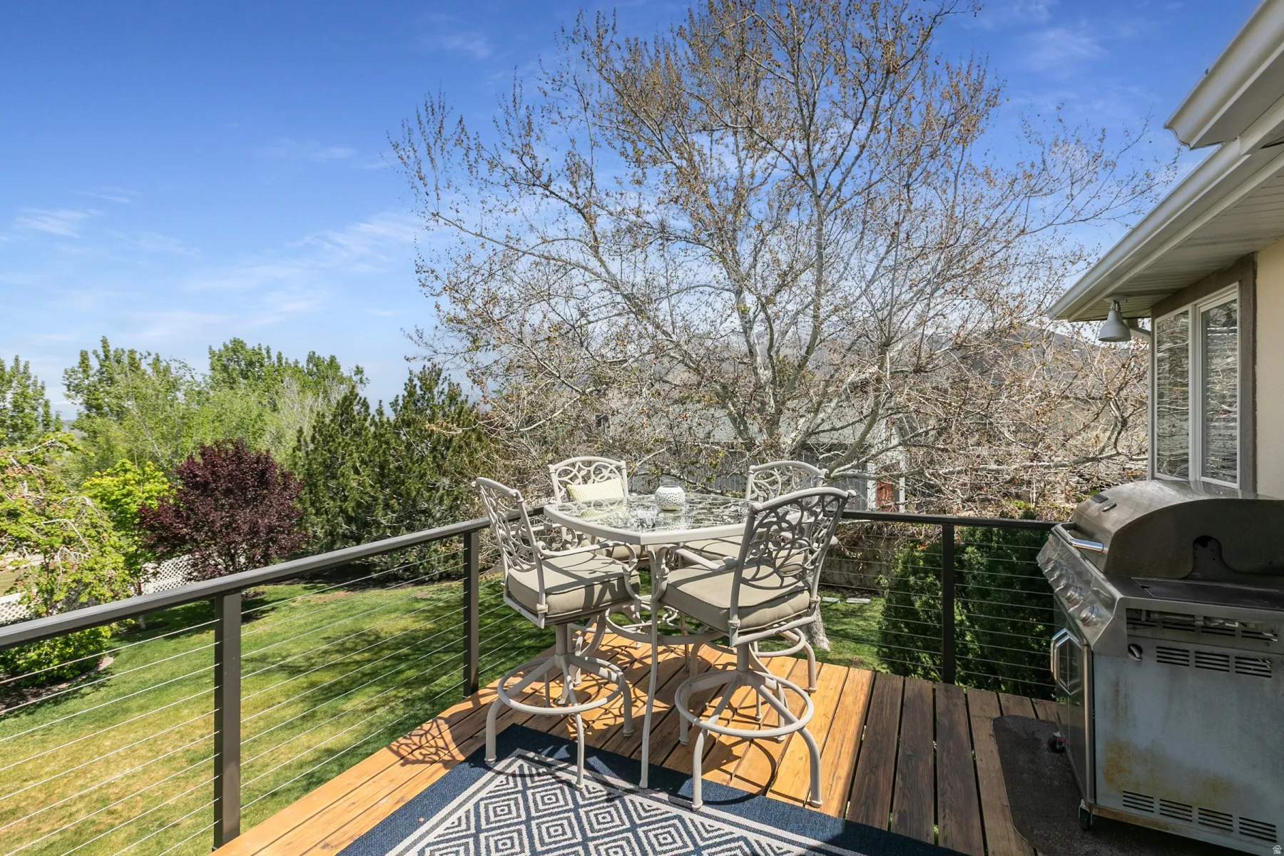 Wooden deck with a grill and outdoor dining area