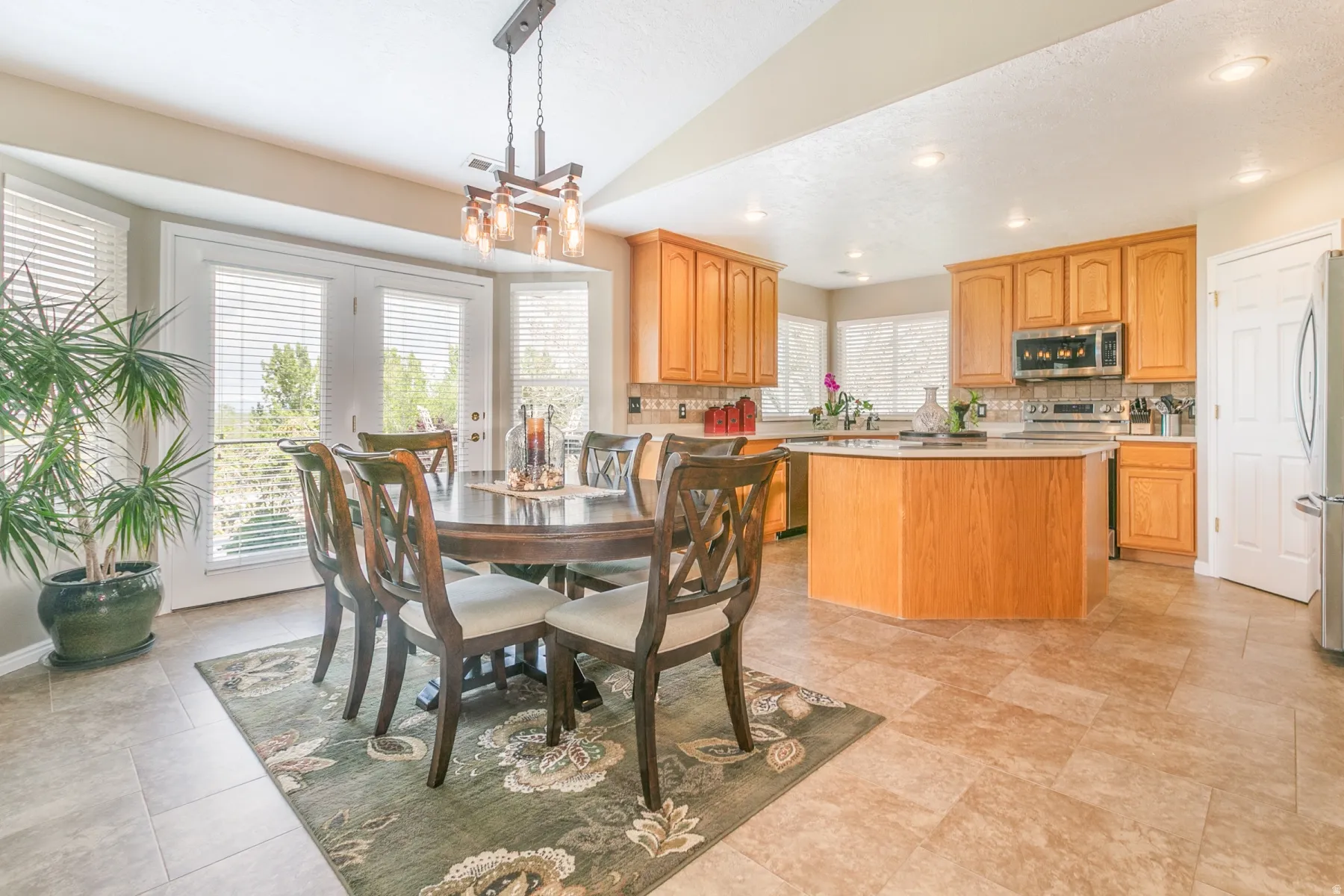 Dining Kitchen area featuring a chandelier and lofted ceiling