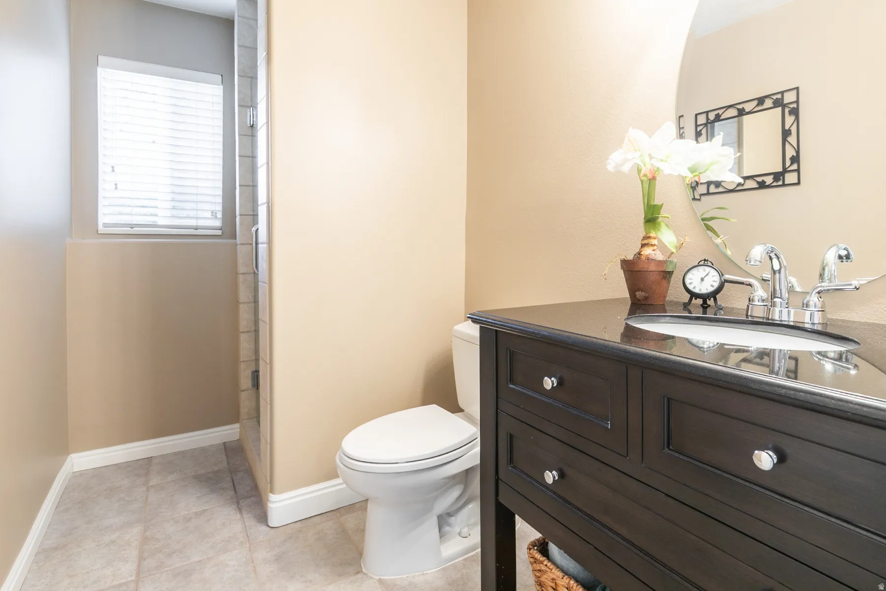 Bathroom featuring vanity, a stall shower, and light tile patterned flooring