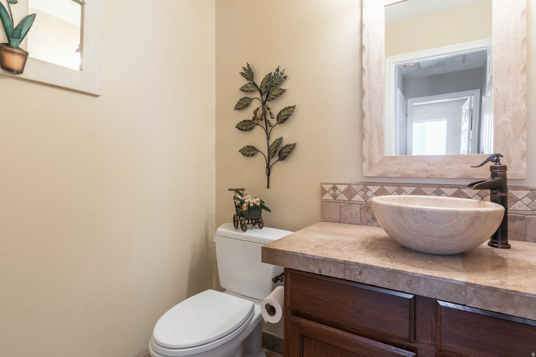 Half bath featuring backsplash and vanity