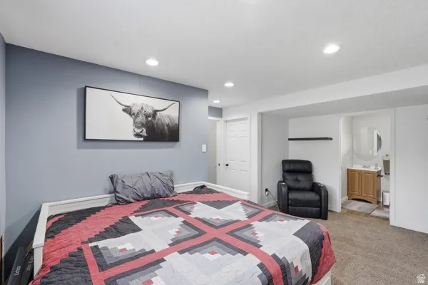Bedroom featuring carpet flooring, recessed lighting, and ensuite bathroom