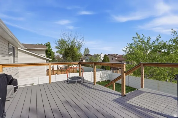 Wooden terrace featuring a residential view