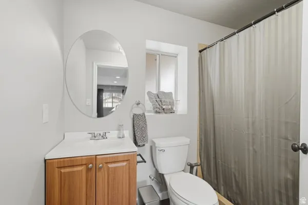 Full bathroom featuring vanity and curtained shower