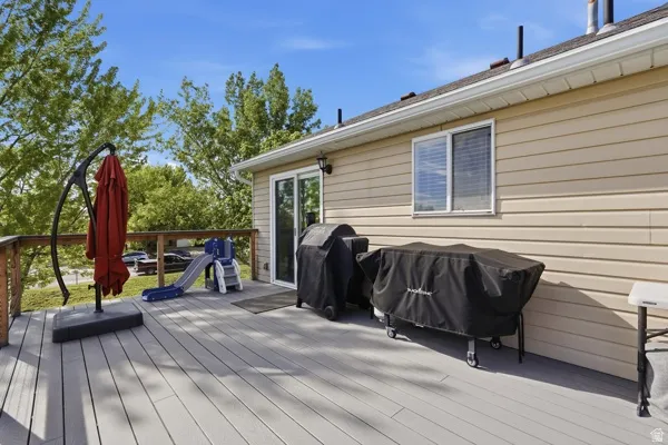 Wooden deck featuring area for grilling