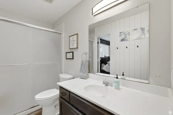 Full bath with vanity, ensuite bathroom, and a shower with shower door