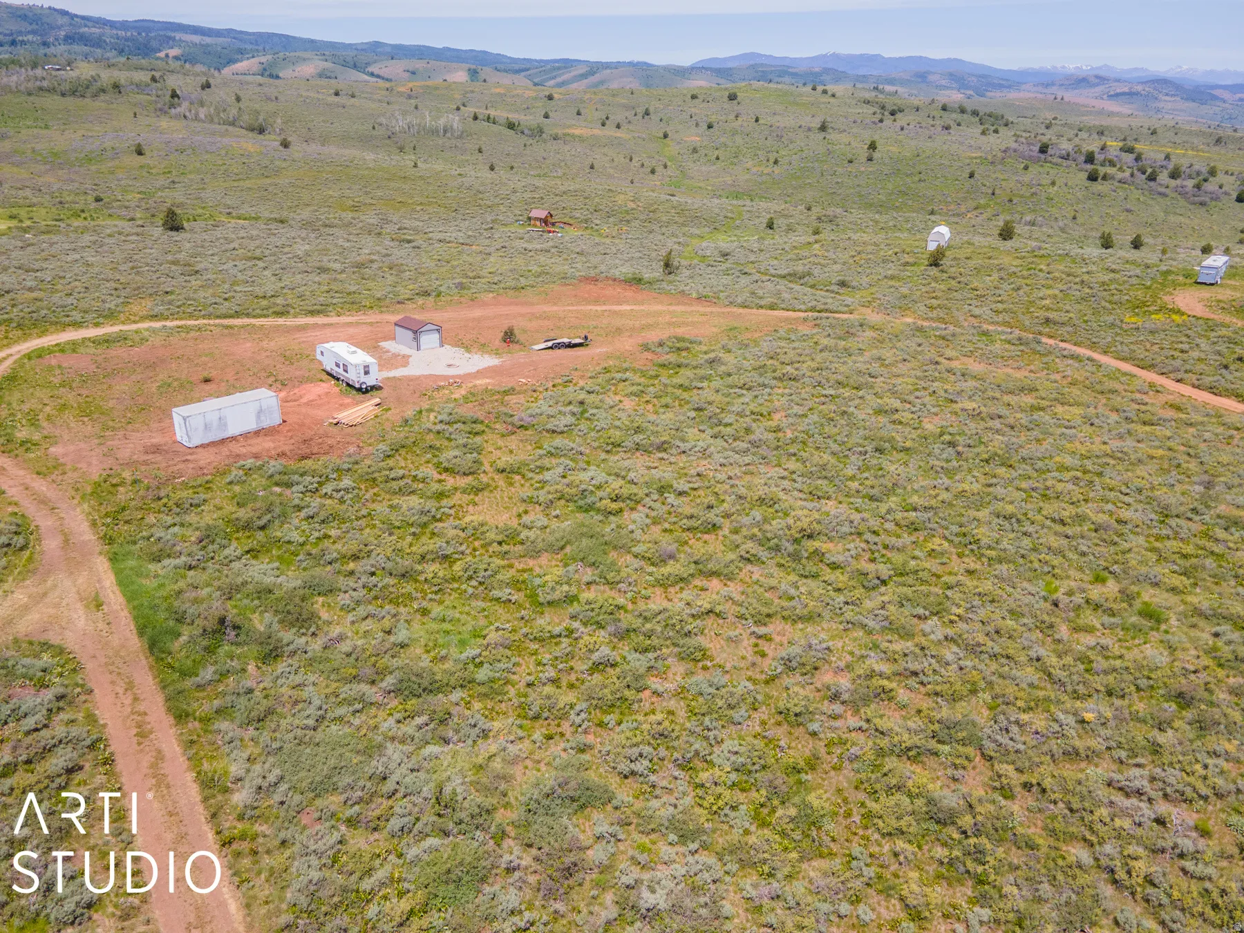 Aerial view of sparsely populated area featuring a mountainous background