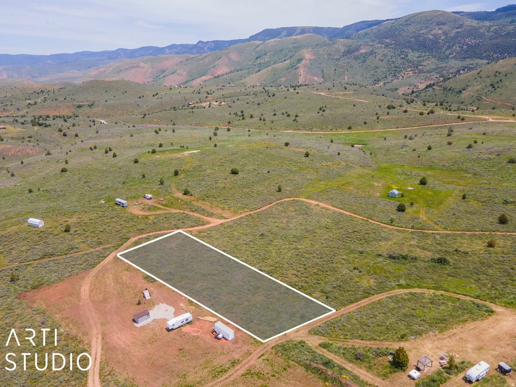 Aerial view of sparsely populated area with property boundaries highlighted and mountains