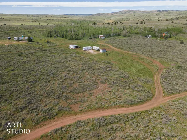 Expansive natural landscape featuring rolling hills and abundant green foliage