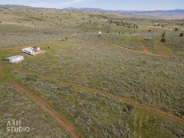 Expansive rural property featuring rolling hills and distant mountainous terrain