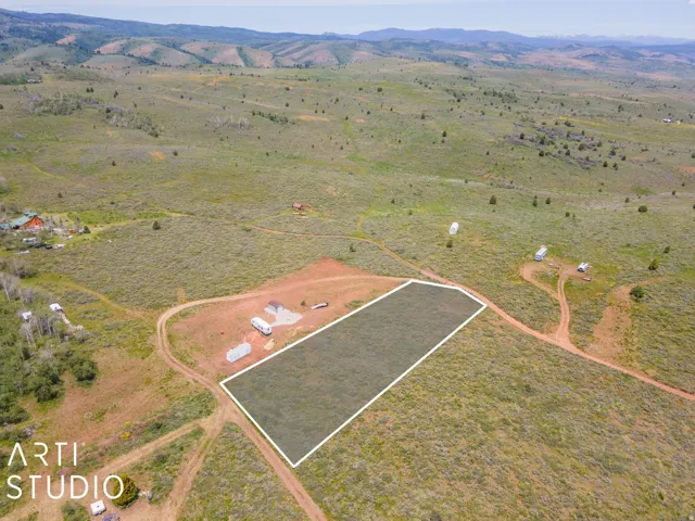 Aerial view of sparsely populated area featuring a mountain backdrop and property boundaries highlighted