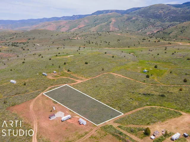 Aerial view of sparsely populated area with property boundaries highlighted and mountains