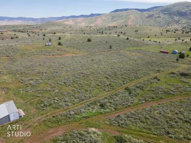 Expansive land parcel featuring natural vegetation and rolling hills